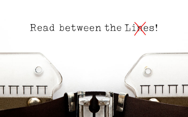 Text Read Between The Lies typed on vintage typewriter. The usually used word in the original idiom Lines is changed to Lies.