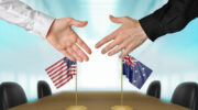 United States and Australia extending their hands for a handshake.