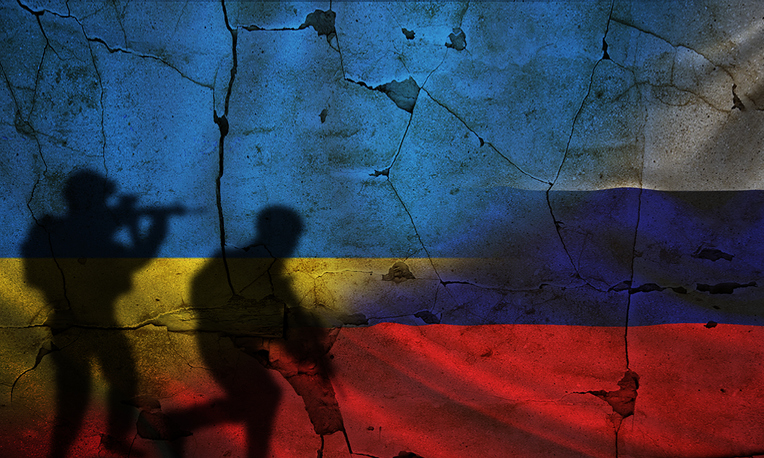 Russia vs Ukraine flag on cracked wall, concept of war between russia and ukraine, silhouette of soldiers on Russia vs Ukraine flag Image:iStock