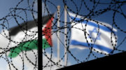 Flags of Israel and Palestine behind the barbed wire.