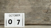 White block calendar present date 7 and month October on wood background