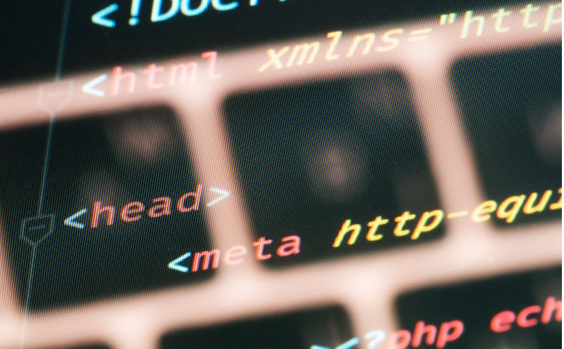 Html document code in text editor with keyboard close-up on the screen Conceptual.