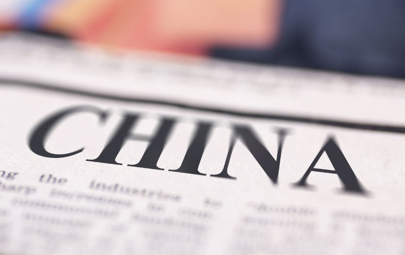China written newspaper close up shot to the text. Image: iStock / ardasavasciogullari