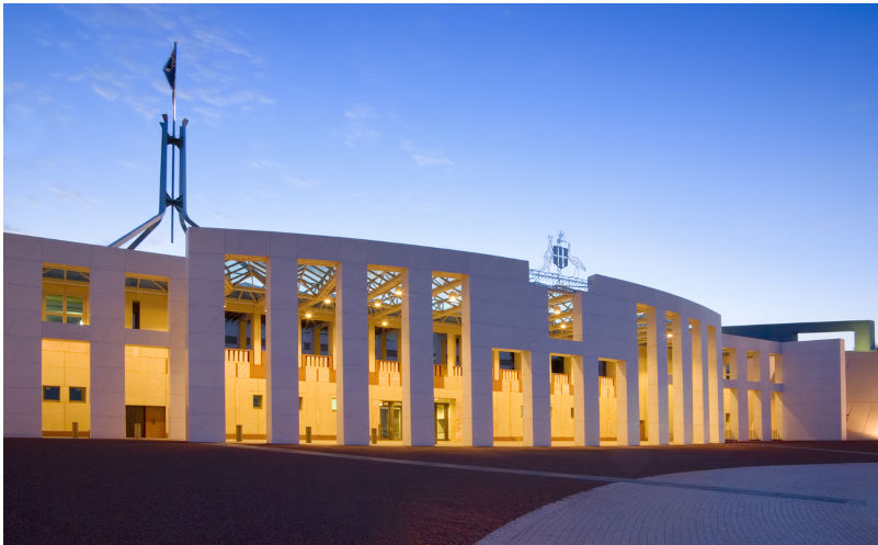 Australian Parliament House illuminated at twilight. Slight motion blur on flag due to long exposure. More Australia