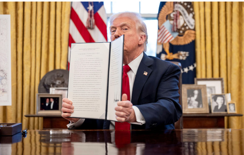 Washington, United States. 26 March, 2025. U.S President Donald Trump, holds up a a signed executive order applying tariffs to all auto imports during a signing ceremony at the Oval Office of the White House, March 26, 2025 in Washington, D.C. Credit: Molly Riley/White House Photo/Alamy Live News. Contributor: White House Photo / Alamy Stock Photo Image ID: 3AA7XRC