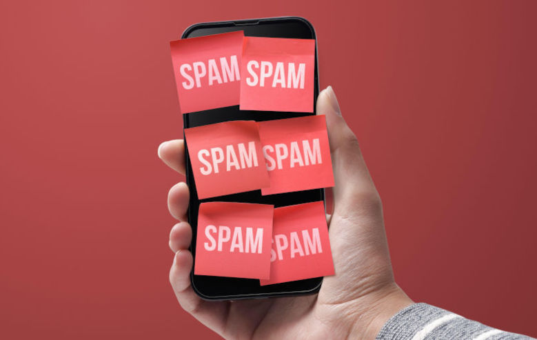 Hand holding a smartphone full of spam texts, cybersecurity concept. Contributor: luciano de polo stokkete / Alamy Stock Photo Image ID: 2J6FM4H