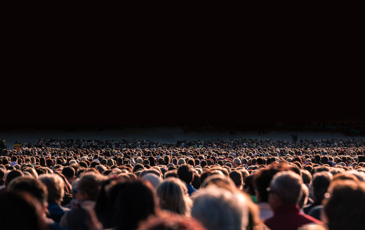 Panoramic photo of large crowd of people. Slow shutter speed motion blur. Image: iStock/:5xinc