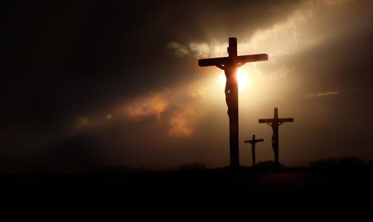 Dramatic light, sky and clouds background, passion of Jesus Christ on Golgotha hill and cross as symbol of Jesus' death and resurrection during Passion Week Image: iStock/artplus