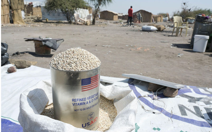 SOUTH SUDAN, Upper Nile state, town Renk, UNHCR refugee transit centre for refugees and returnees from Sudan war, cooking oil tin can of US AID, the US agency for international development aid, filled with grain. Contributor: Joerg Boethling / Alamy Stock Photo Image ID: 2SBJ81H