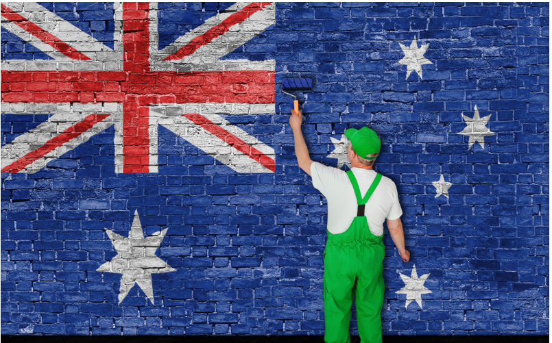 Australian flag painted over old brick wall by house painter. Image: iStock / thumb