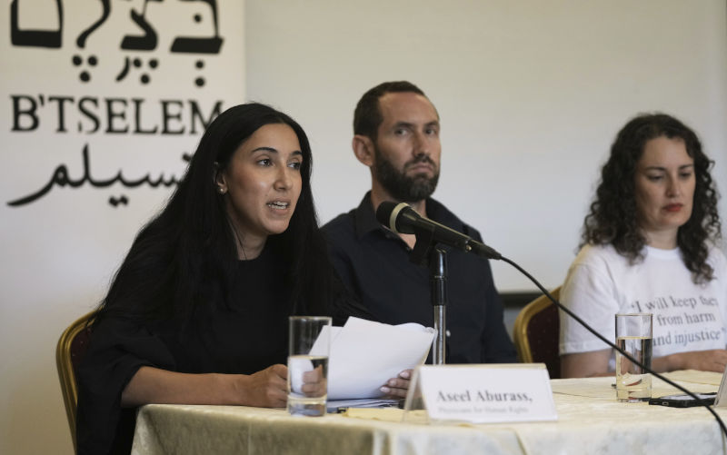 Aseel Aburass, left, of PHRI (Physicians for human Rights Israel) speaks at a press conference with B'Tselem, the Israeli Information Center for Human Rights in the Occupied Territories, releasing a report, "Our Genocide," calling the war in Gaza a genocide, and PHRI's legal-medical analysis of the systematic destruction of Gaza's healthcare system, in Jerusalem, Monday, July 28, 2025. Image: AAP/AP/Maya Alleruzzo