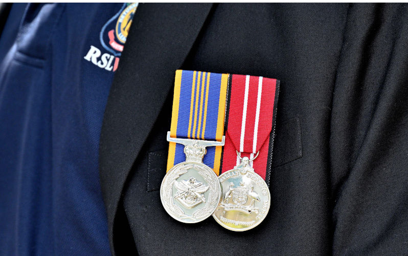 A closeup of two Anzac medals pinned on the jacket of an RSL member. Image: Alamy Contributor: Wirestock, Inc. Image ID:2JJTW4H