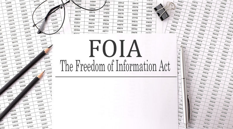 Paper with The Freedom of Information Act FOIA on a table with chart. Image iStock / CreditIryna Drozd