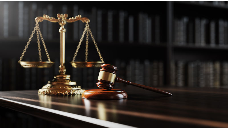 Legal concept Scales of justice and and the judges gavel hammer as a symbol of law and order on the background of books. Image iStock / CreditAlexander Sikov