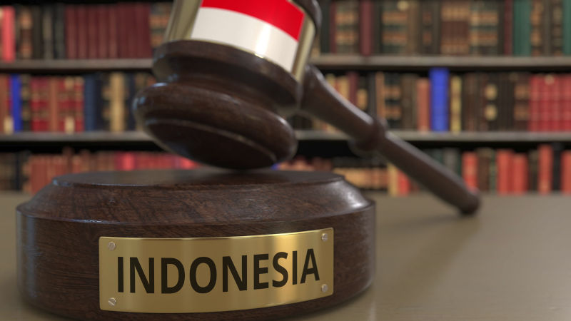 Flag of Indonesia on falling judges gavel in court. National justice or jurisdiction related conceptual 3D rendering ImaheiStock Credit alexeynovikov