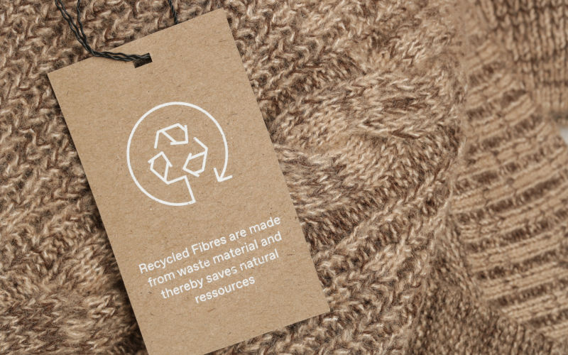 Close up of clothing tag with recycle icon. Recycling products concept. Zero waste, suistainale production, environment care and reuse concept. Image iStock Credit Credittriocean