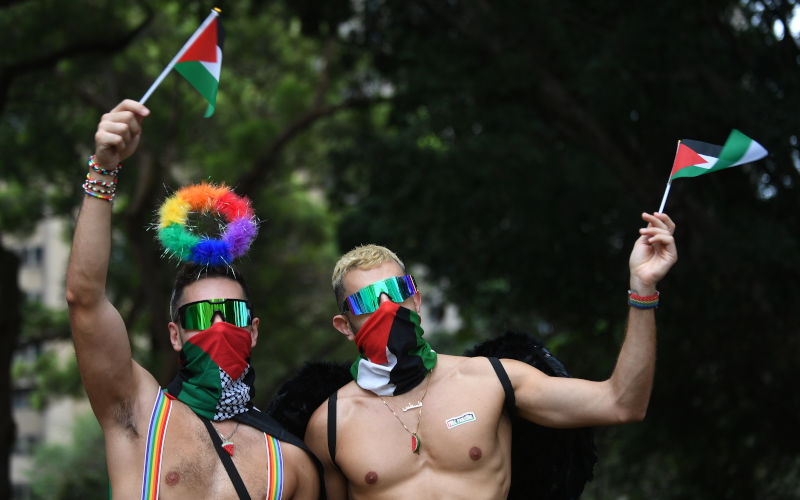 People wave Palestinian flags during the 46th annual Sydney Gay and Lesbian Mardi Gras Parade in Sydney, Saturday, March 2, 2024. Image AAP Photo Steven Saphore