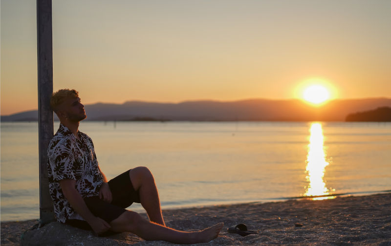Shadow of a man at the seashore, sunset behind. ImageiStock Eva Casas