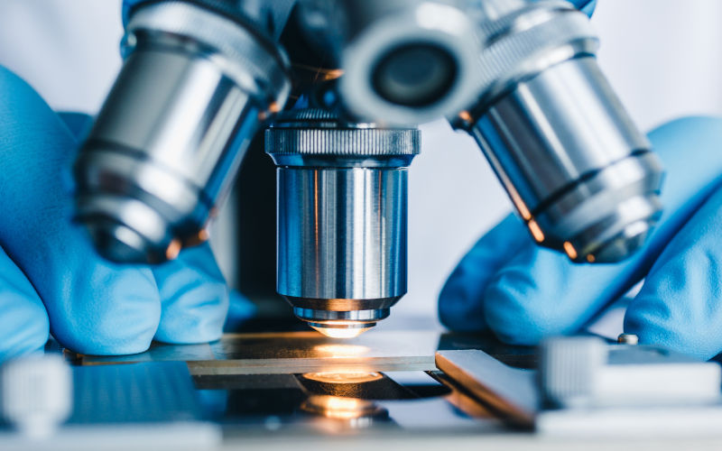 Close up shot of microscope with metal lens at laboratory. imageiStock Credit Kkolosov