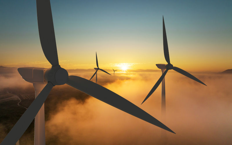 Wind turbine silhouette at sunrise, wind energy. Image IStock piyaset