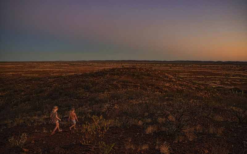 Cheela Plains, Western Australia, 01 07 2021. Young children walk in the flat landscape of Pilbara region. Image iStock Daniiielc