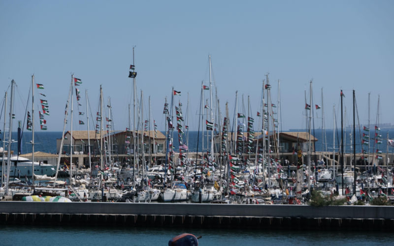 Global Sumud Flotillas Spring 2026 mission at Porto Xiphonio in Augusta, Sicily, prior to heading toward Gaza. More than 60 sailboats are moored at the port with activists aboard. Some images capture the moment select vessels exit the harbor. The fleet displays Palestinian flags and banners reading Break the Siege. Crowds gathered on shorelines on April 29, 2026, as preparations advanced to challenge Israel?s naval blockade and address the Gaza humanitarian crisis. Image Alamy ID3EC5XND