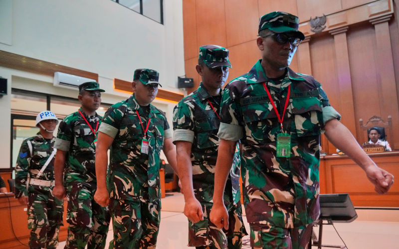 A military police person, far left, escorts Indonesian military personnel, from left, Sami Lakka, Nandala Dwi Prasetya, Budhi Hariyanto Widhi Cahyono, and Edi Sudarko, accused of an acid attack on human right activist Andrie Yunus, during trial at a military court in Jakarta, Indonesia, Wednesday, April 29, 2026. ImageAP Photo Tatan Syuflana