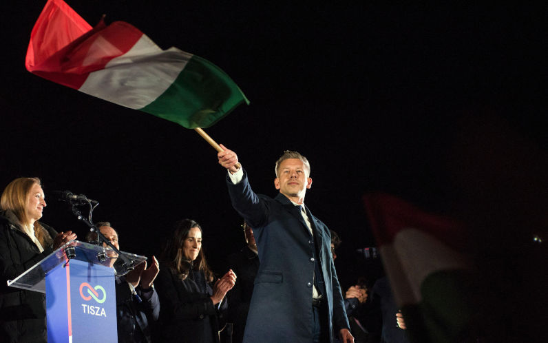 Peter Magyar waves the Hungarian flag after his speech during the TISZA partys election night event in Budapest. April 12, 2026, marked the most significant political transformation in Hungary in decades. The election night for Peter Magyars TISZA party in Budapest saw thousands of citizens gathering to celebrate a decisive victory over Prime Minister Viktor Orbans Fidesz party, which had been in power since 2010.Peter Magyar, who emerged as a central opposition figure only two years ago, successfully mobilized a record number of voters by focusing his campaign on anticorruption measures. Image SIPA USA Alamy image ID 3E88FK5