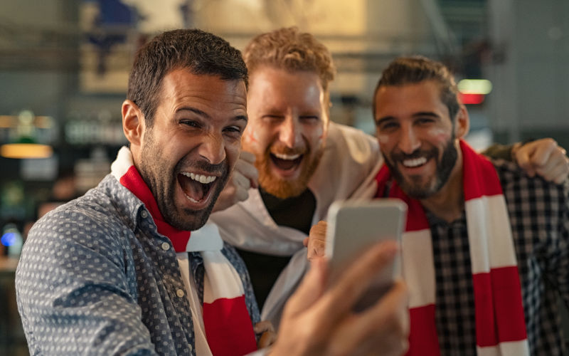 Happy supporters cheering and exulting after winning an online bet. ImageiStock Ridofranz