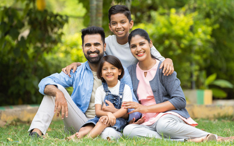 Happy indian couple with kids embracing by looking at camera while sitting at park. Image Alamy Contributorlakshmiprasad S Image ID 2T5AEE3