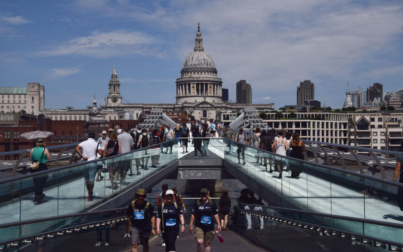 London, England, UK. 27th June, 2026. People walk across Millennium Bridge with a view of St Pauls Cathedral as the heatwave continues in UK and Europe. Image Zuma Press Wire Vuk Valcic ZUMA Press Alamy ID 3EWJ9HN