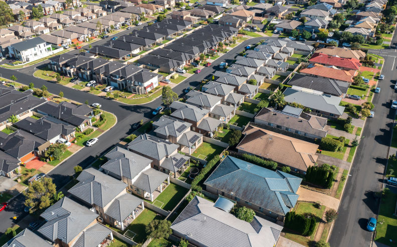 Aerial view of rows of mass produced cookie cutter style homes built during the 2010s in outer suburban Sydney, Australia. Image iStock Harlz