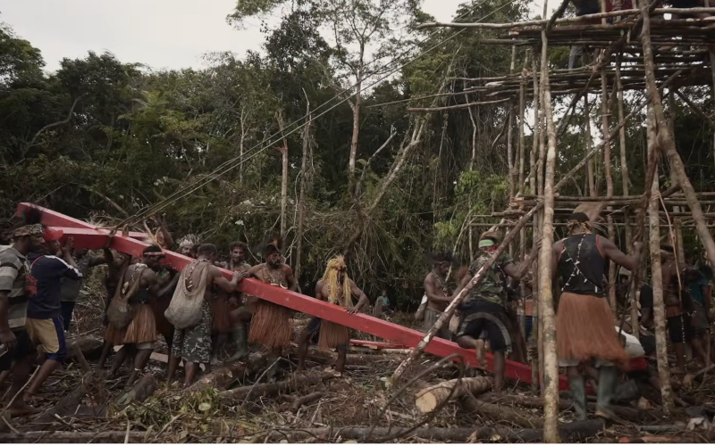 Villagers in West Papua erect a giant red cross as a deterrent to indigenous lands being taken. Screenshot from Pesta Babi YouTube Jubi TV