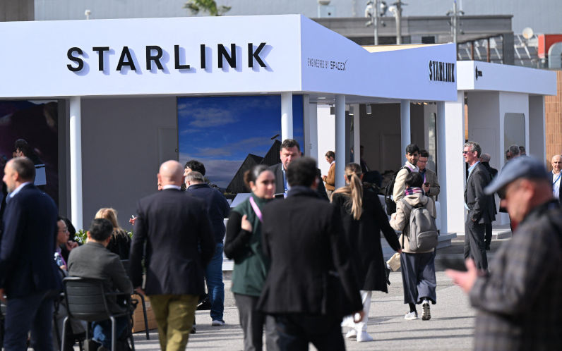 Barcelona, Spain. 03rd Mar, 2026. Visitors to the Mobile World Congress (MWC) mobile communications trade fair walk past the stand of US entrepreneur Elon Musks satellite internet provider Starlink. Deutsche Telekom has signed an agreement with Starlink to close its last wireless gaps with satellite internet connections from 2028. Image Wolf von Dewitz dpa Alamy Live News Image ID3DXHHA2