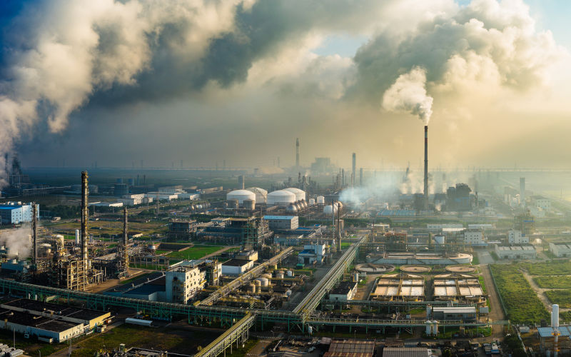 Aerial shot of a large chemical plant and oil refinery with smoking chimneys in unnamed industrial area. ImageiStock zhaojiankang