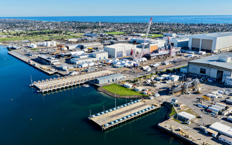 Aerial view of Osborne, South Australia, featuring the ASC Shipyard, Port River, Torrens Island, industrial waterfront, shipping facilities, and surrounding coastal wetlands. This image captures one of Adelaides most significant maritime and defense industry precincts, showcasing navigable waterways, port infrastructure, industrial development, salt marsh ecosystems, and the meeting of urban industry with the natural coastal environment. Ideal for projects related to maritime transport, defense, shipbuilding, logistics, engineering, infrastructure, industry, environmental management, geography, and South Australias industrial coastline. ImageiStock iTraveller