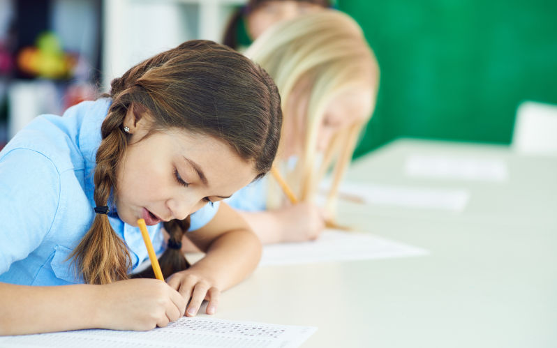 Diligent primary students taking a test Image iStock itmediaphotos