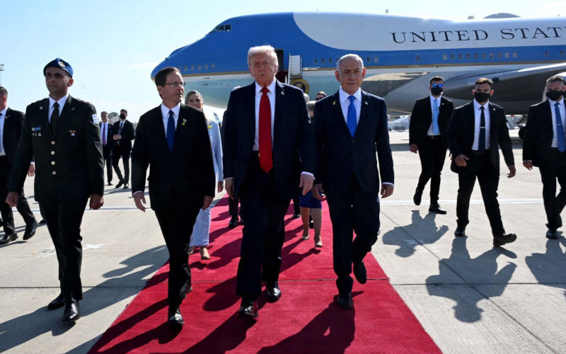 U.S President Donald Trump walks with President Isaac Herzog, left, and Prime minister Benjamin Netanyahu during an arrival ceremony at Ben Gurion International airport on Monday Oct 13, 2025. Image Alamy GPO handout photo via Newscom. Image ID 3CWNGM1