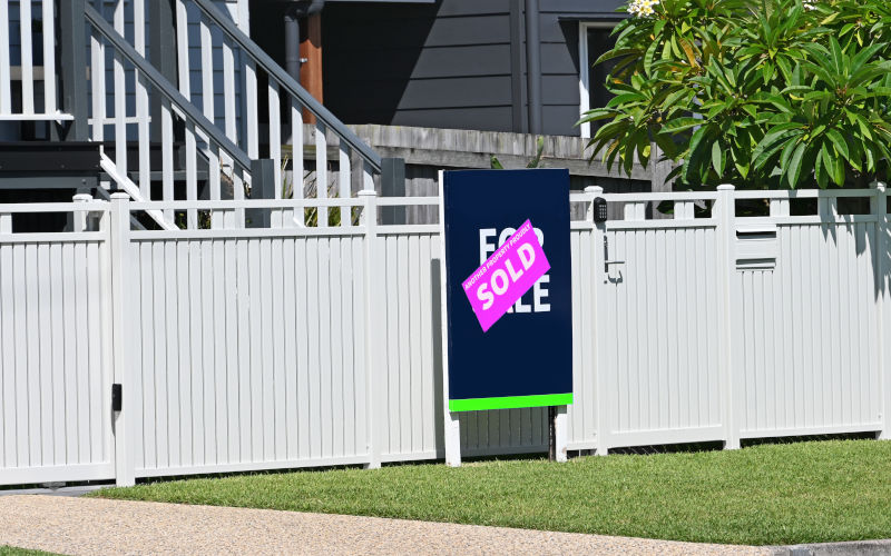 For sale sign in front of a property with a sold sticker over the top. Image iStock Douglas Cliff