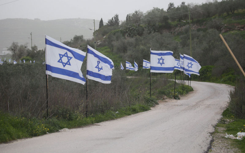 Jewish settlers hang Israeli flags and banners in the Masoudiya neighborhood near the town of Sebastia, Jewish settlers hang Israeli flags and banners in the Masoudiya neighborhood near the town of Sebastia, north of Nablus in the West Bank. February 13, 2026. Image IMAGO Mohammed Nasser Alamy Image ID 3DP6MBN