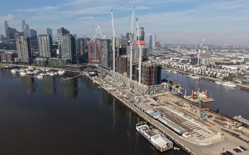 Melbourne, Victoria, Australia July 9, 2026 Aerial view of Victoria Harbour waterfront redevelopment and highrise construction cranes at Docklands precinct. ImageiStock GoAerials