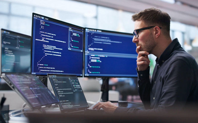 Software Engineer uses laptop and touchscreen to develop secure algorithms. Image Alamy Andriy Popov Alamy image ID 3F2CA6F