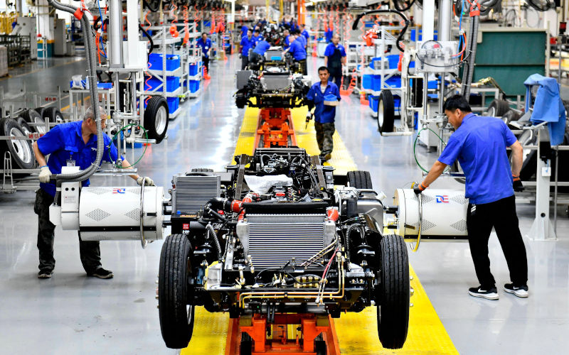 JINAN, Workers assemble automobiles at the production line of Weichai New Energy Commercial Vehicle Co., Ltd. in Wendeng District of Weihai City, east China s Shandong Province, July 21, 2023. The district is committed to developing automobiles, new energy and new materials, electronic information and medicine industries. The proportion of hightech industry output value in the district has risen to 60 percent. Image Alamy PhotographerIMAGO Guo Xulei Image ID 2RRTEHH