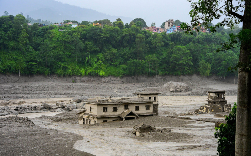 Flash floods and mudslides devastate Nuwakot, Nepal NUWAKOT, NEPAL AUGUST 26, 2026 An aftermath view of flash floods and mudslides along the Trishuli River. A catastrophic flash flood swept through Nepals northern border region after an ice and rock avalanche, reportedly triggered by an earthquake, caused a sudden surge in the Lhende River on the Nepal China border and sent massive volumes of water, mud and debris downstream into the Bhote Koshi and Trishuli river systems. The disaster devastated settlements in Rasuwa and Nuwakot districts, sweeping away homes, roads, bridges, vehicles,debris and human life. Image Alamy IMAGO Safal Prakash Shrestha Image ID3FCA868