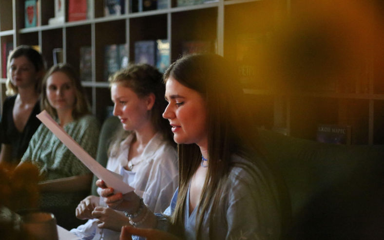 Teen poets at a reading in a bookstore. Image SOPA images Alamy. Alamy image ID 2XKAK1J