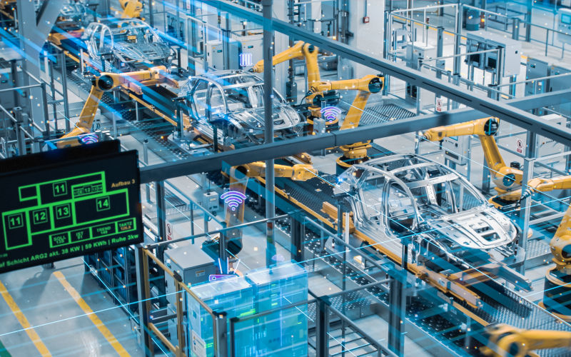 Car Factory Digitalization Industry 4.0 5G Automated Robot Arm Assembly Line Manufacturing HighTech Electric Vehicles. Production efficiency. Image iStock Credit gorodenkoff