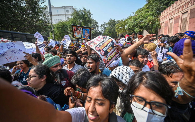 NEW DELHI, INDIA OCTOBER 10 Security personnel detain protesters belonging to various student, political and civil society organisations during a demonstration called by the Cockroach Janta Party CJP against the Election Commission of India ECI, demanding the resignation of Chief Election Commissioner Gyanesh Kumar over alleged irregularities in the Special Intensive Revision SIR of electoral rolls at Baba Kharak Singh Marg on October 10, 2026. Image Alamy Imago Hindustan Times