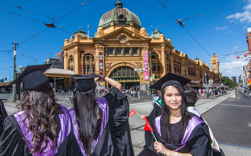 RMIT university graduation day the students walk along the Swanton St in Melbourne city for celebration day in graduation day Image iStock Totty