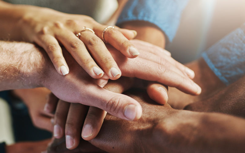 Hands coming together in a symbolic gesture of social togetherness or social cohesion. Image iStock Peopleimages