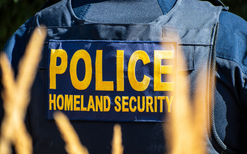 Provo, Utah, USA September 15, 2025 Back view of a tactical vest labeled Police Homeland Security worn by a law enforcement officer in an outdoor area. Image iStock CharlesMcClintock Wilson
